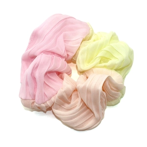 Three pleated chiffon scrunchies in pastel pink, yellow, and peach for women