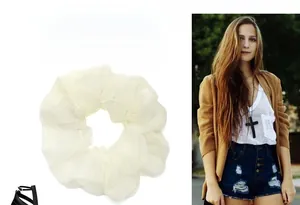 Detailed texture of off-white organza scrunchie with subtle pearlescent shimmer and soft mesh