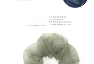 Detail view of sparkly organza scrunchies in navy blue and mint green with sheer texture