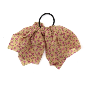 Floral chiffon bow hair tie with pink flower pattern on beige fabric base