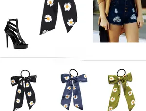Detail of floral daisy print ribbon hair scrunchies in black, navy blue and army green