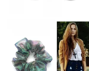 Close-up of iridescent mermaid fabric hair scrunchie with dreamy laser gradient texture