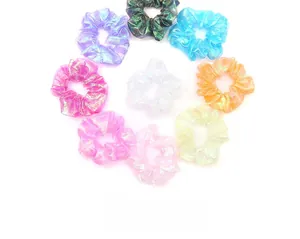 Close-up of iridescent organza scrunchies in various pastel colors and pearly textures