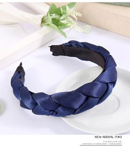 Detail of blue braided silk headband on a white ceramic tray with elegant decor