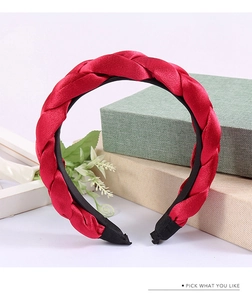 Detail of red silk satin braided headband showing twisted texture and anti-slip tips