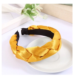 Detail of bright yellow braided silk headband with high top texture and non-slip lining