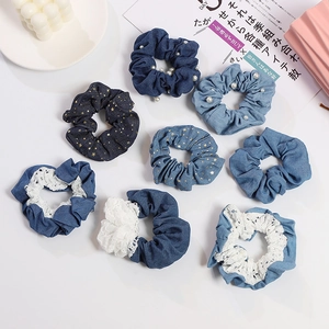 Set of eight denim fabric hair scrunchies with pearls and gold star patterns