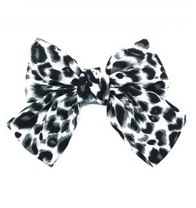 Détail d'une grande pince à cheveux en velours avec motif léopard noir et gris élégant