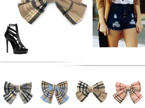 Close-up of four plaid bow hair clips in grey, sky blue, camel, and pink wool fabric