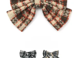 Macro detail of plaid bow hair clips featuring wool textured fabric in three colors