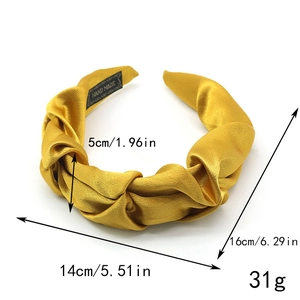 Bright yellow pleated satin headband with handmade label and elegant twisted knot design
