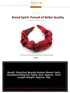 Red pleated satin headband with 13cm diameter showing glossy texture and handmade label