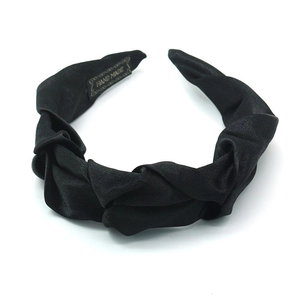 Elegant black pleated satin headband with twisted knot design and handmade label