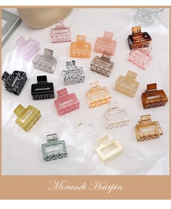 Flat lay of Morandi color rectangular hollow hair claws set on white fabric