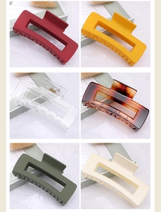 Detail view of six square hair claws in matte and glossy finishes and various colors