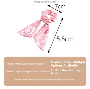 Pink satin hair scrunchie with white paisley print showing 7cm diameter and ribbon dimensions
