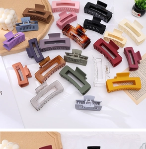 Close-up of matte and transparent acrylic hair claw clips in various elegant colors