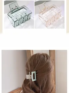 Detail of hollow rectangular hair claw clips in translucent resin with sturdy metal spring