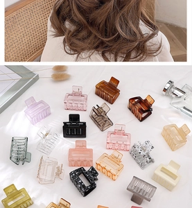 Detailed view of assorted hollow square hair claws in various colors and patterns