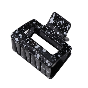Modern hollow rectangular hair claw with black and white splatter pattern