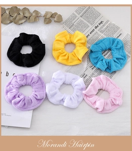 Detail of six colorful towel fabric hair scrunchies in minimalist Morandi style