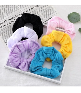 Detail of six candy-colored plush towel fabric scrunchies in a stylish set