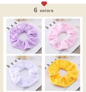 Detail showing plush terry cloth scrunchies in purple, pink, white, and yellow tones