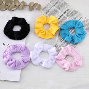 Set of six candy-colored terry cloth scrunchies in black, yellow, blue, and pink