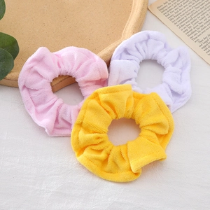 Three-piece towel fabric scrunchies set in pink, purple, and yellow soft terry cloth