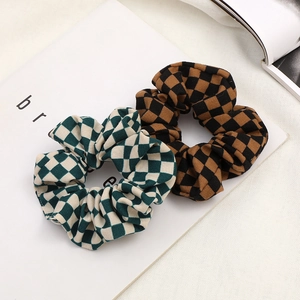Fashionable checkerboard scrunchies set in green and brown fabric on a white background
