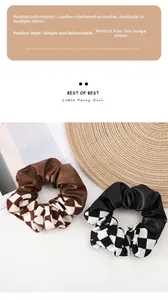 Detailed view of fashionable checkerboard pattern fabric and leather hair scrunchies