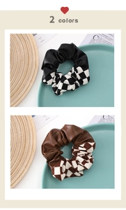 Detail of checkered and leather scrunchies in classic black and mocha brown colors