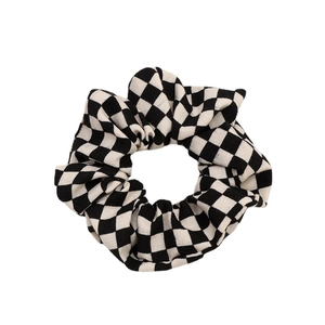 Classic black and white checkerboard scrunchie hair tie with ruffled fabric texture