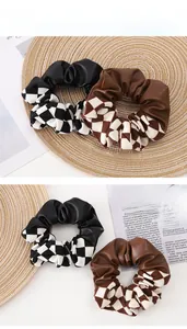 Detail of checkerboard pattern scrunchies showing leather stitching and fabric textures