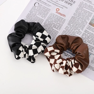 Checkerboard pattern and PU leather patchwork scrunchie hair tie in black and brown tones