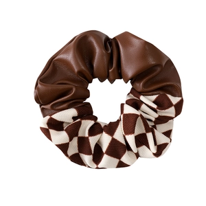 Brown faux leather and checkerboard fabric scrunchie with a stylish spliced design