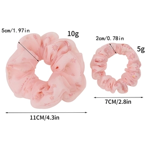 Size comparison chart for pink daisy mesh hair scrunchies in two different dimensions