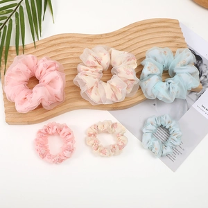 Floral organza scrunchies set in pink and blue for elegant bun hair styling