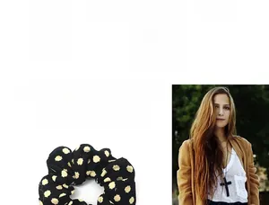 Close-up of black and yellow polka dot scrunchie with high elasticity and elegant fabric texture