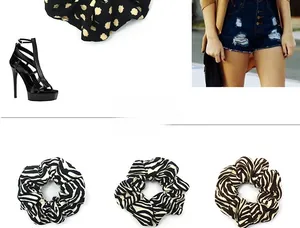 Close-up of fabric scrunchies in polka dot and zebra patterns for hair styling