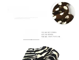 Detailed texture of fabric scrunchies in brown polka dot and zebra stripe patterns