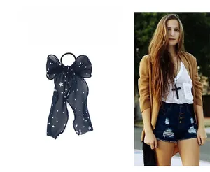 Detail showing navy blue chiffon ribbon with white stars pattern and high elastic hair tie
