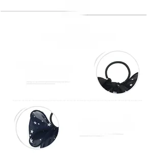 Detail of navy blue chiffon scrunchie with white star pattern and ribbon bow style