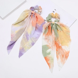 Bohemian print scrunchies with long ribbons in purple and green abstract patterns