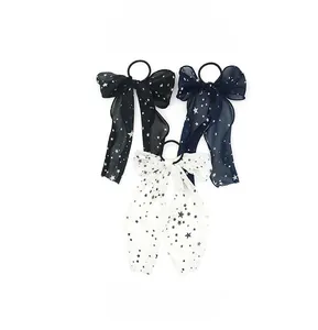 Detailed close-up of bow hair scrunchies with star patterns and chiffon streamers
