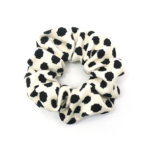 French vintage white scrunchie with black polka dots and soft ribbed fabric texture