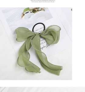 Detail view of light green chiffon bow scrunchie with high-elastic band and refined stitching