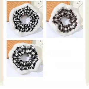 Détail de trois chouchous à carreaux avec bordure en peluche en motifs pied-de-poule et marron