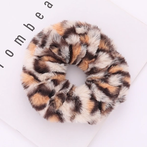 Detailed view of plush leopard print faux fur hair scrunchie with soft fluffy texture