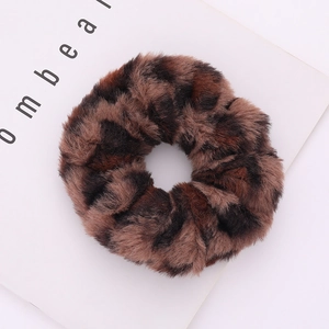 Detailed view of plush leopard print scrunchie showing faux rabbit fur texture and leopard pattern
